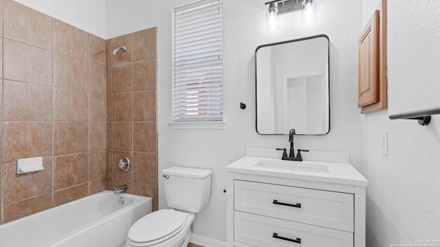 full bathroom with vanity, toilet, and tiled shower / bath