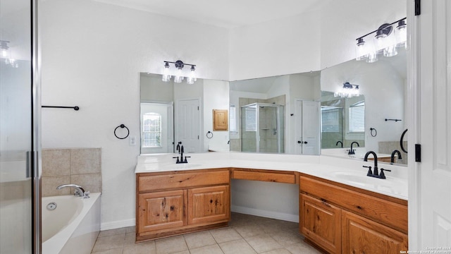 bathroom with tile patterned floors, vanity, independent shower and bath, and a wealth of natural light