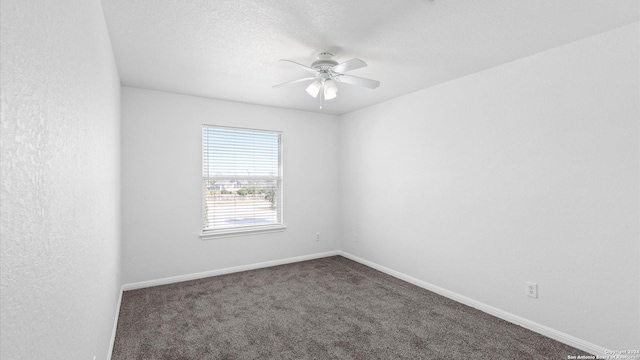 carpeted spare room featuring ceiling fan and a textured ceiling