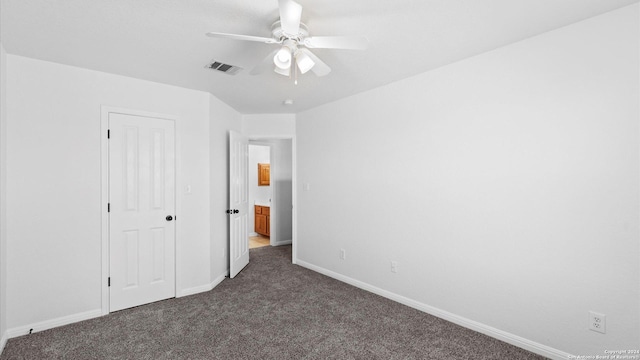 unfurnished bedroom with dark carpet and ceiling fan