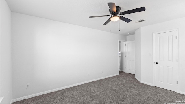 unfurnished bedroom featuring ceiling fan and dark colored carpet