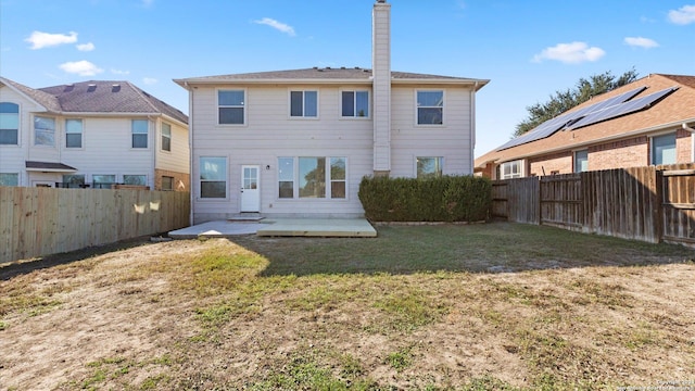 back of property featuring a yard and a patio