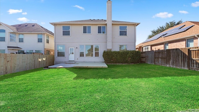 rear view of property featuring a patio area and a yard