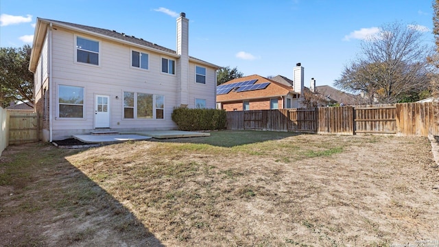 rear view of house with a patio area and a yard