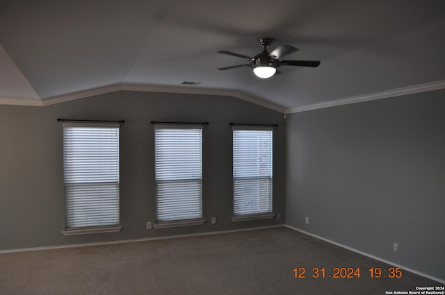 carpeted empty room with ceiling fan, lofted ceiling, and ornamental molding