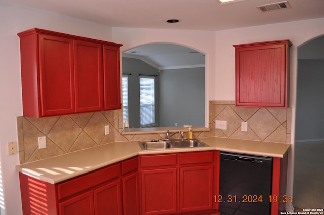 kitchen with tasteful backsplash, dishwasher, vaulted ceiling, and sink