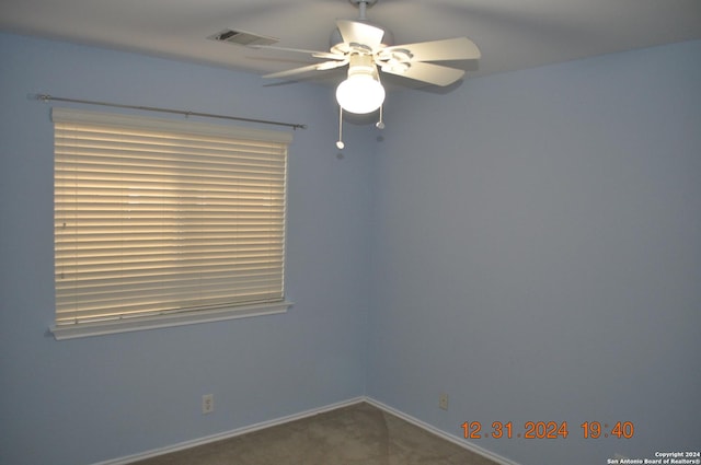 empty room featuring carpet flooring and ceiling fan