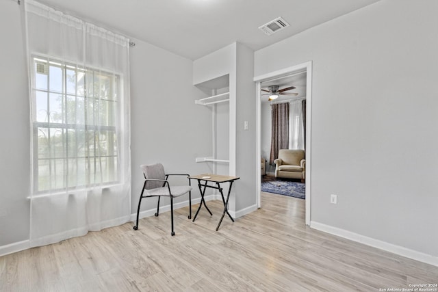 sitting room featuring ceiling fan and light wood-type flooring