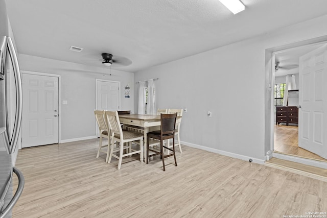 dining room with ceiling fan and light hardwood / wood-style flooring