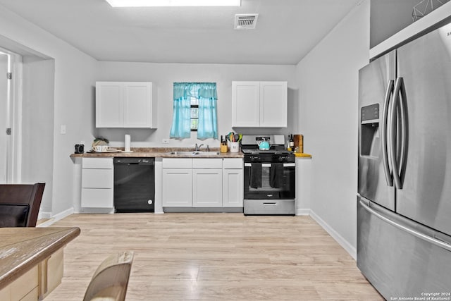 kitchen featuring white cabinets, sink, light wood-type flooring, and stainless steel appliances