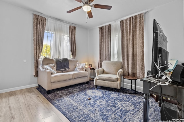 living room with ceiling fan and hardwood / wood-style flooring