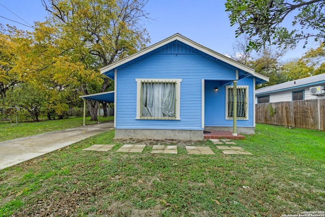 back of house with a yard and a carport