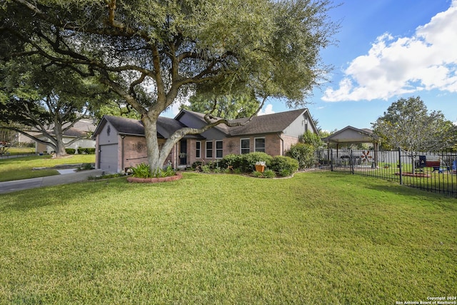 single story home with a front yard and a garage