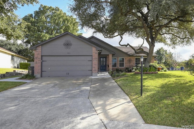 ranch-style house featuring a garage and a front yard