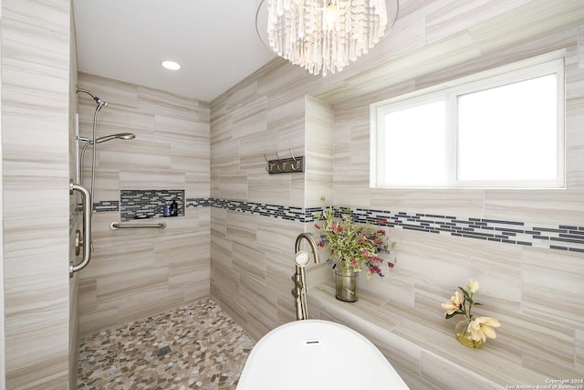 bathroom with shower with separate bathtub, tile walls, and a notable chandelier