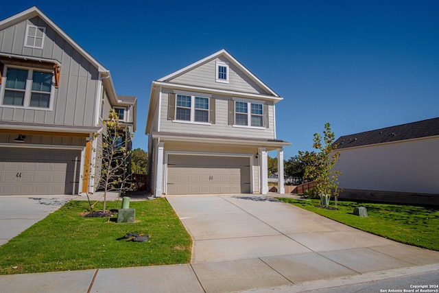 view of front of house featuring a garage and a front lawn