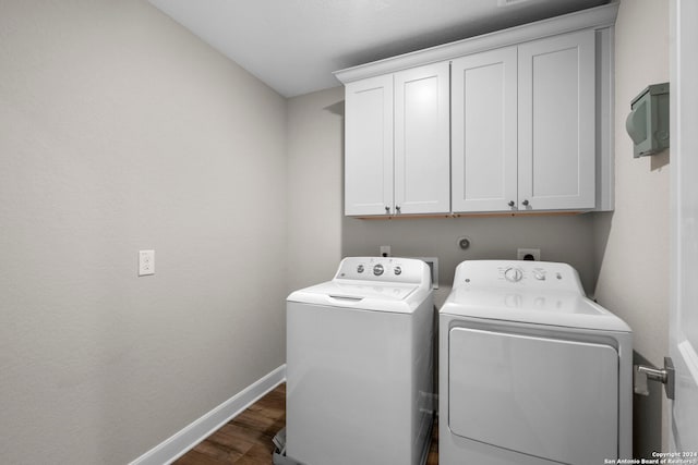 washroom with washer and clothes dryer, cabinets, and dark hardwood / wood-style floors