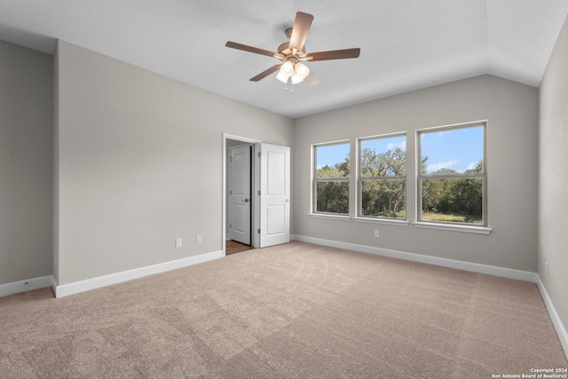 unfurnished bedroom featuring light carpet, ceiling fan, and lofted ceiling