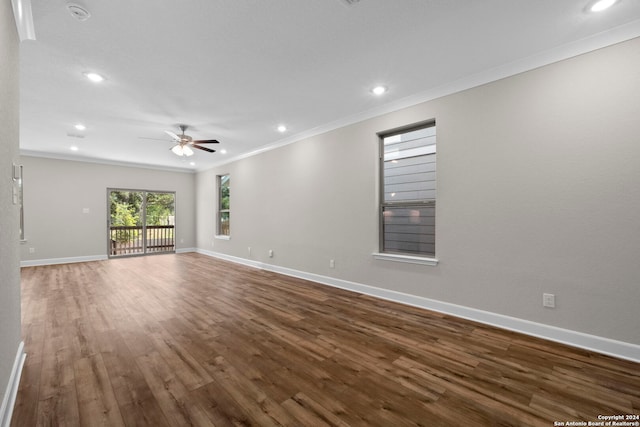 unfurnished living room featuring ceiling fan, ornamental molding, and dark wood-type flooring