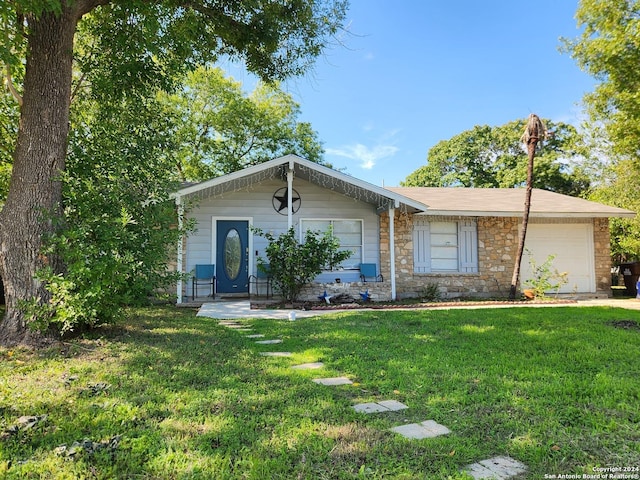 single story home with a garage and a front lawn