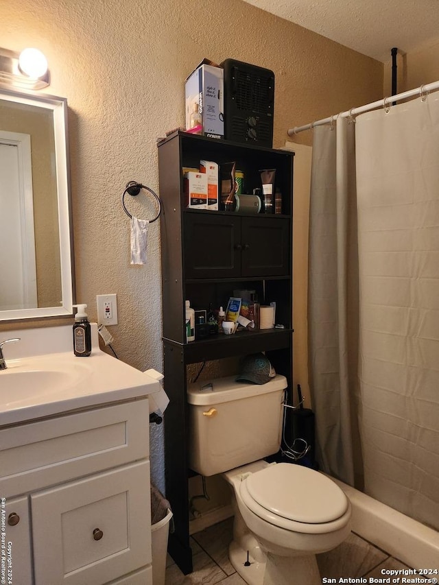 bathroom with tile patterned floors, vanity, toilet, and walk in shower