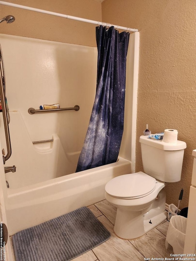 bathroom with toilet and shower / tub combo with curtain