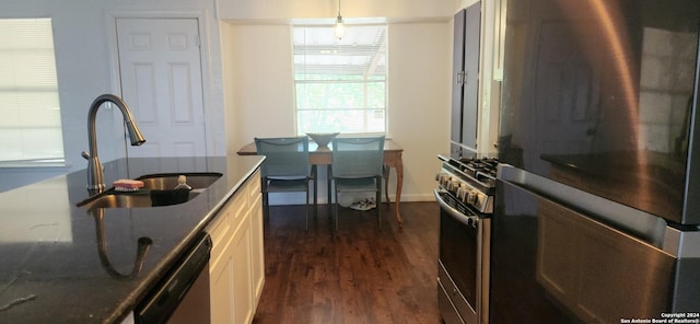 kitchen with sink, white cabinetry, dark wood-type flooring, and appliances with stainless steel finishes