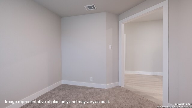 empty room featuring light colored carpet