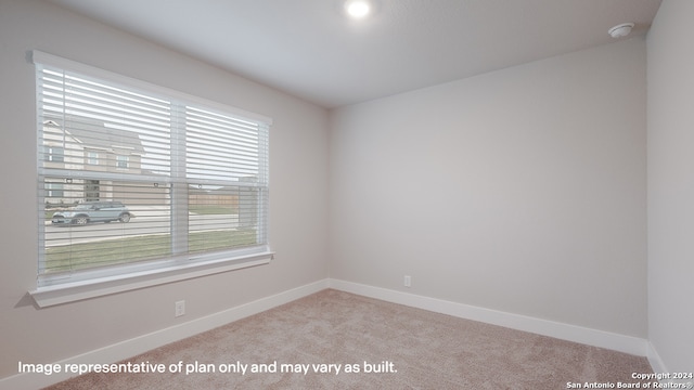 spare room with light colored carpet