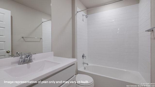 full bathroom with vanity, tiled shower / bath combo, and toilet