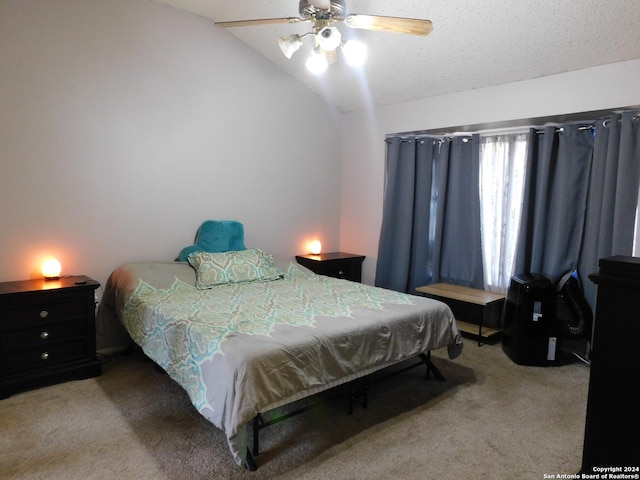 carpeted bedroom with a textured ceiling, ceiling fan, and vaulted ceiling