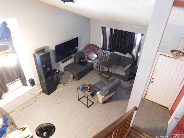 living room featuring hardwood / wood-style floors and a textured ceiling