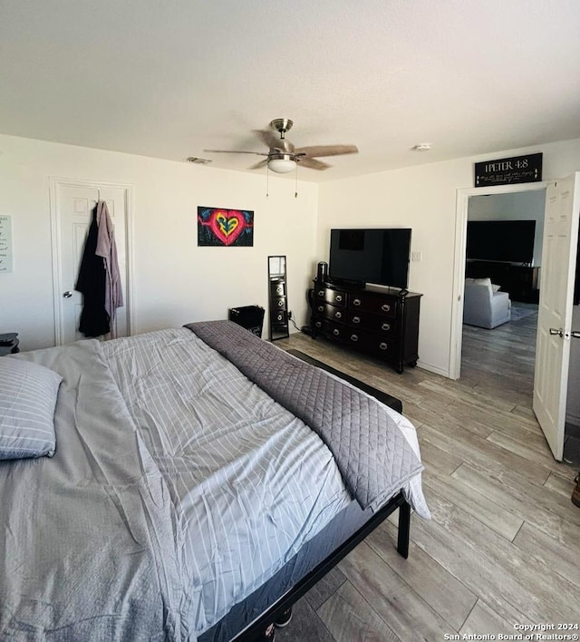 bedroom with ceiling fan and light hardwood / wood-style floors