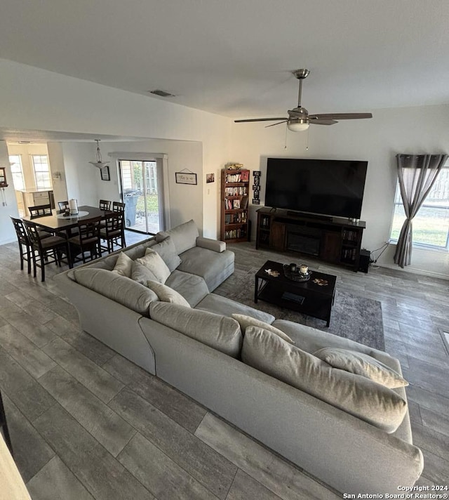 living room with hardwood / wood-style flooring and ceiling fan