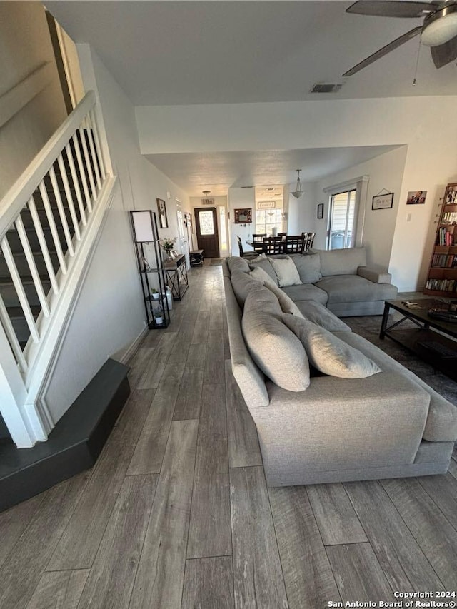 living room featuring dark hardwood / wood-style floors and ceiling fan