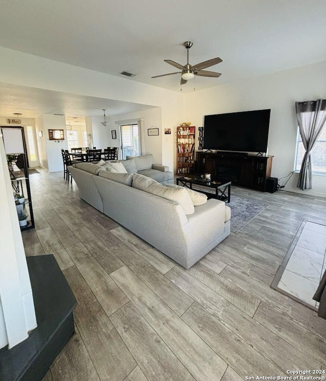 living room with ceiling fan and hardwood / wood-style floors