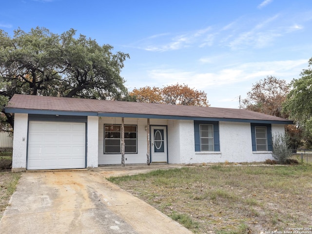 ranch-style home with covered porch and a garage