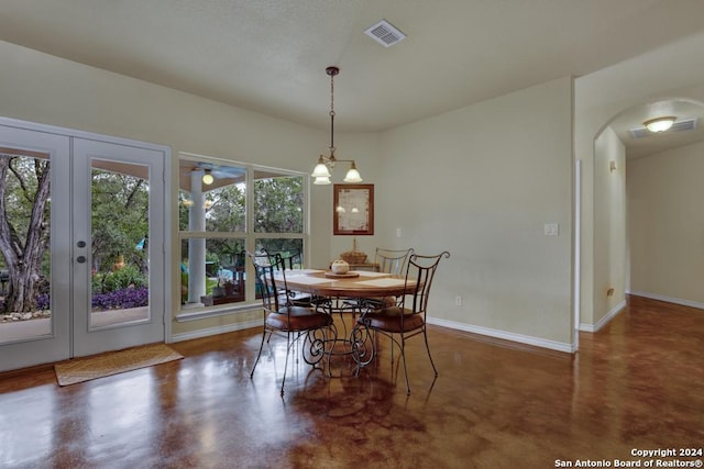 dining space with a chandelier and french doors