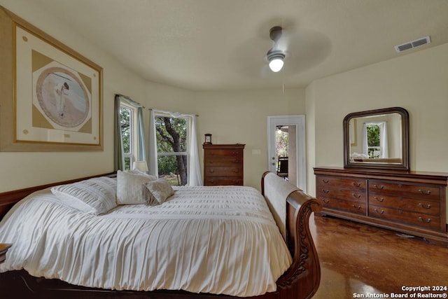 carpeted bedroom featuring multiple windows and ceiling fan