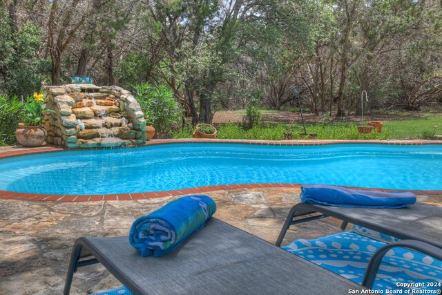 view of swimming pool with a patio area