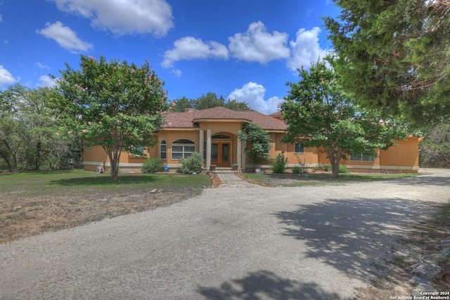 mediterranean / spanish-style house with french doors