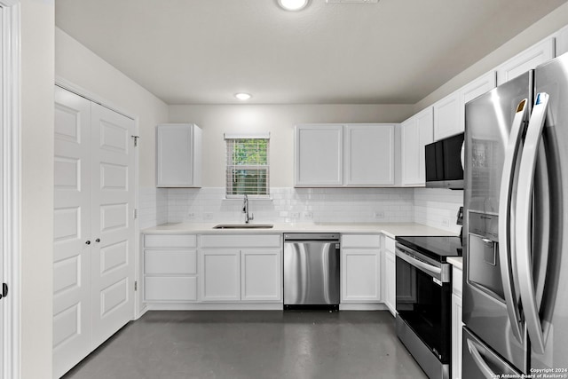 kitchen with white cabinets, backsplash, sink, and stainless steel appliances