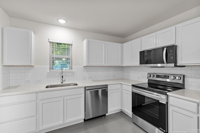 kitchen featuring stainless steel appliances, white cabinetry, tasteful backsplash, and sink