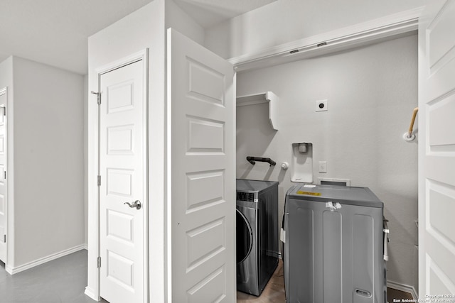 clothes washing area with washer and dryer