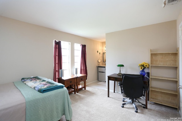 carpeted bedroom with stainless steel refrigerator