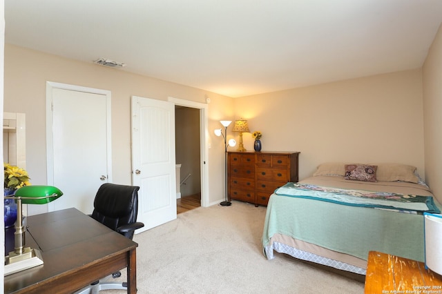 bedroom featuring light colored carpet