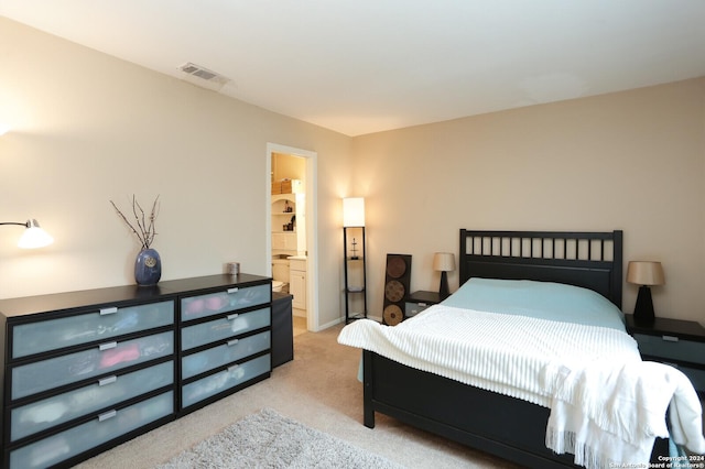 carpeted bedroom with connected bathroom