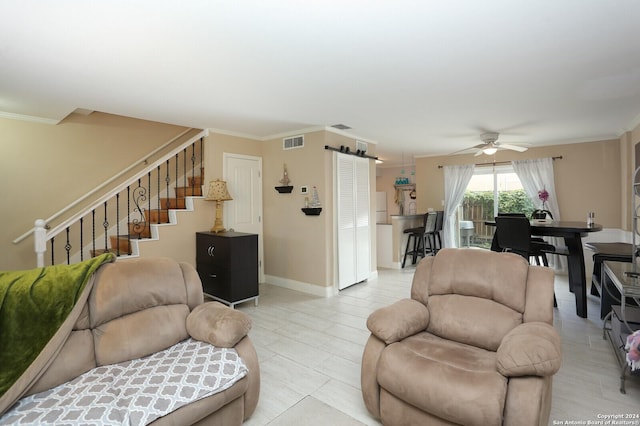 living room featuring ceiling fan, light tile patterned flooring, and crown molding