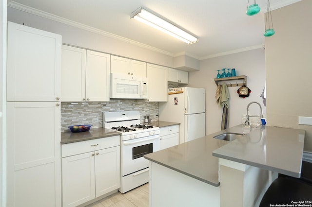 kitchen featuring white cabinets, pendant lighting, white appliances, and sink