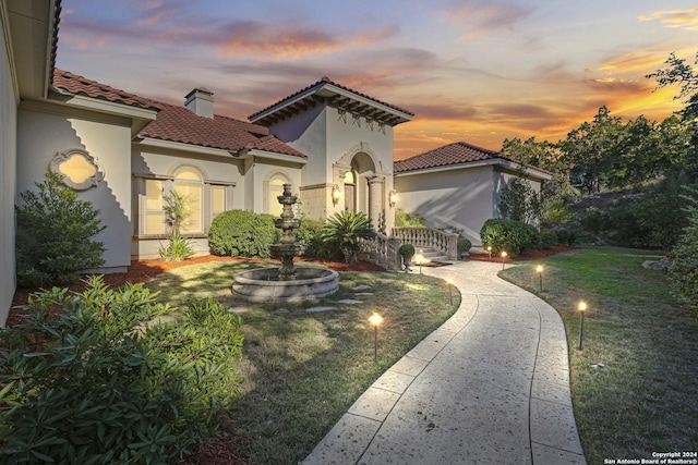 mediterranean / spanish-style home featuring a lawn